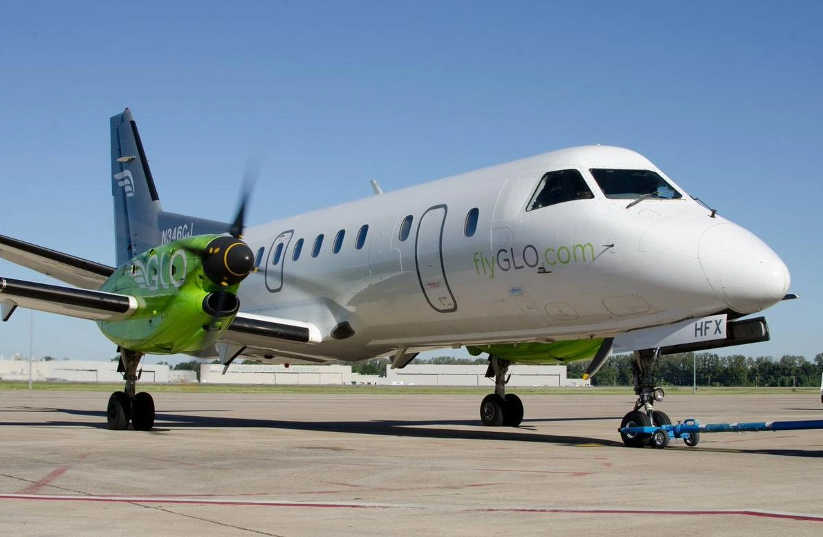 The GLO identity on a Saab aircraft, with the bright green engine nacelle and gray tail.
